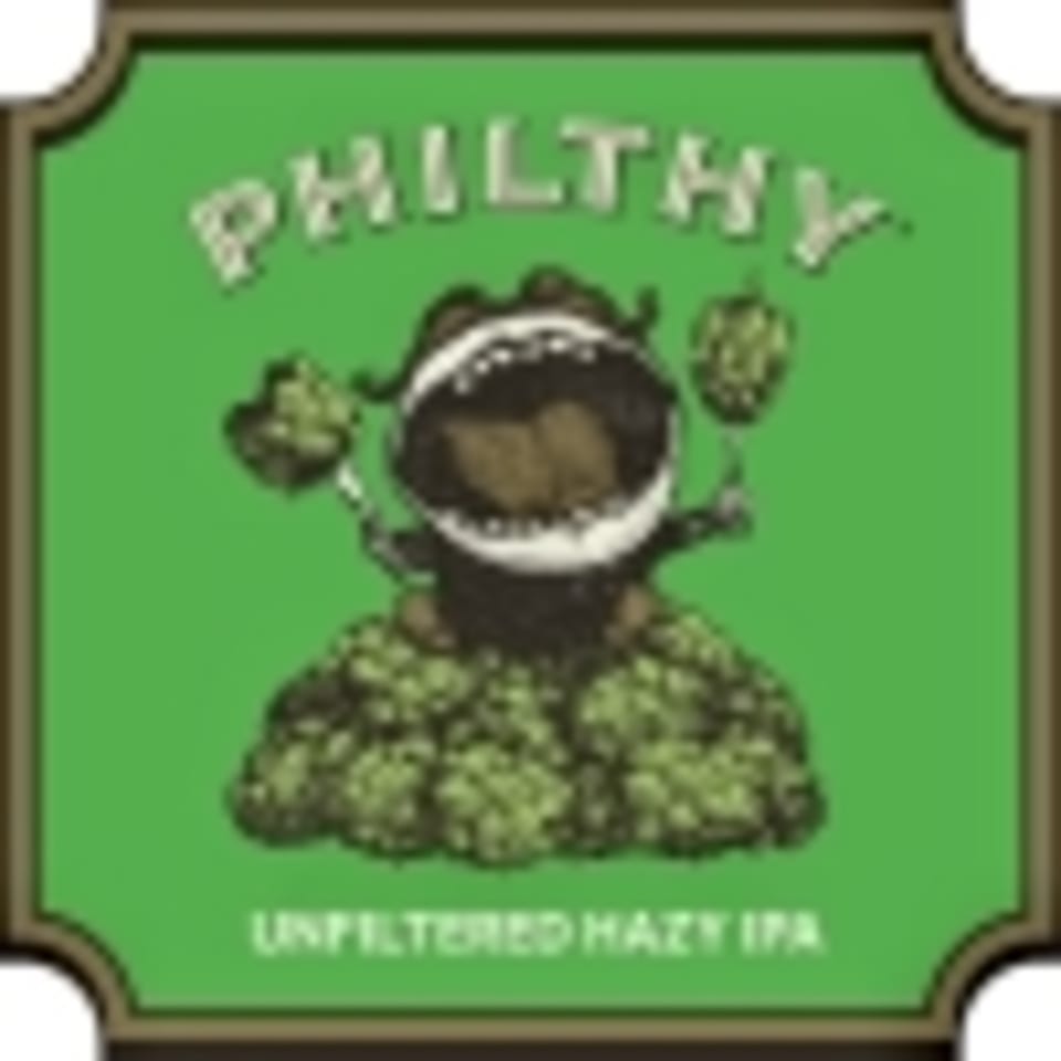 Green label for "Philthy Unfiltered Hazy IPA" beer, featuring a monster eating hops.