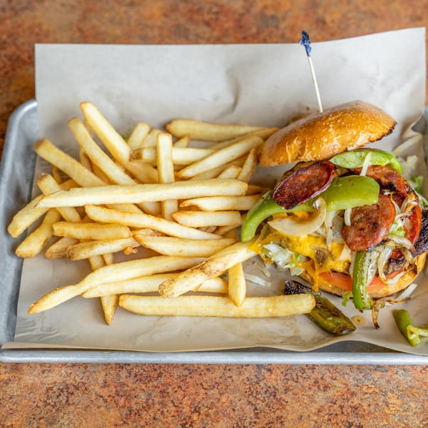 Timothy's Lionville burger with cheese, peppers, onions, sausage, and fries on a tray.